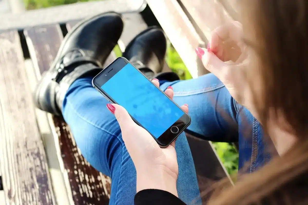 A hand entering a PIN code or pattern on a smartphone lock screen, with a secure folder icon visible, symbolizing authentication and controlled access to private data.