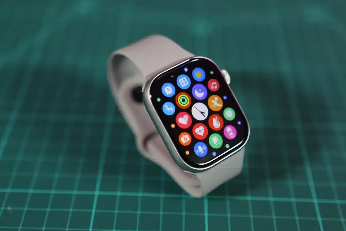 Premium smartwatch with titanium case under bright light, AMOLED display glowing with vibrant colors, showing outdoor GPS navigation interface on screen