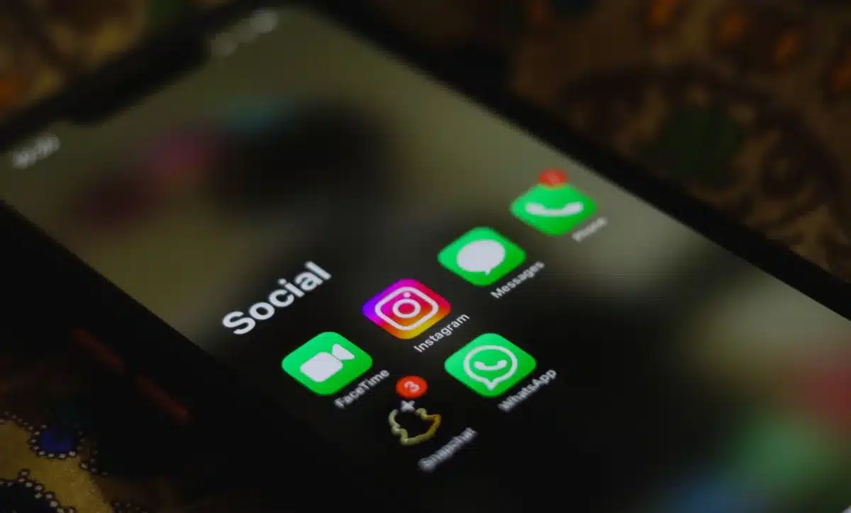 Dispositivo rastreador ovalado junto a pantalla de smartphone mostrando app de localización