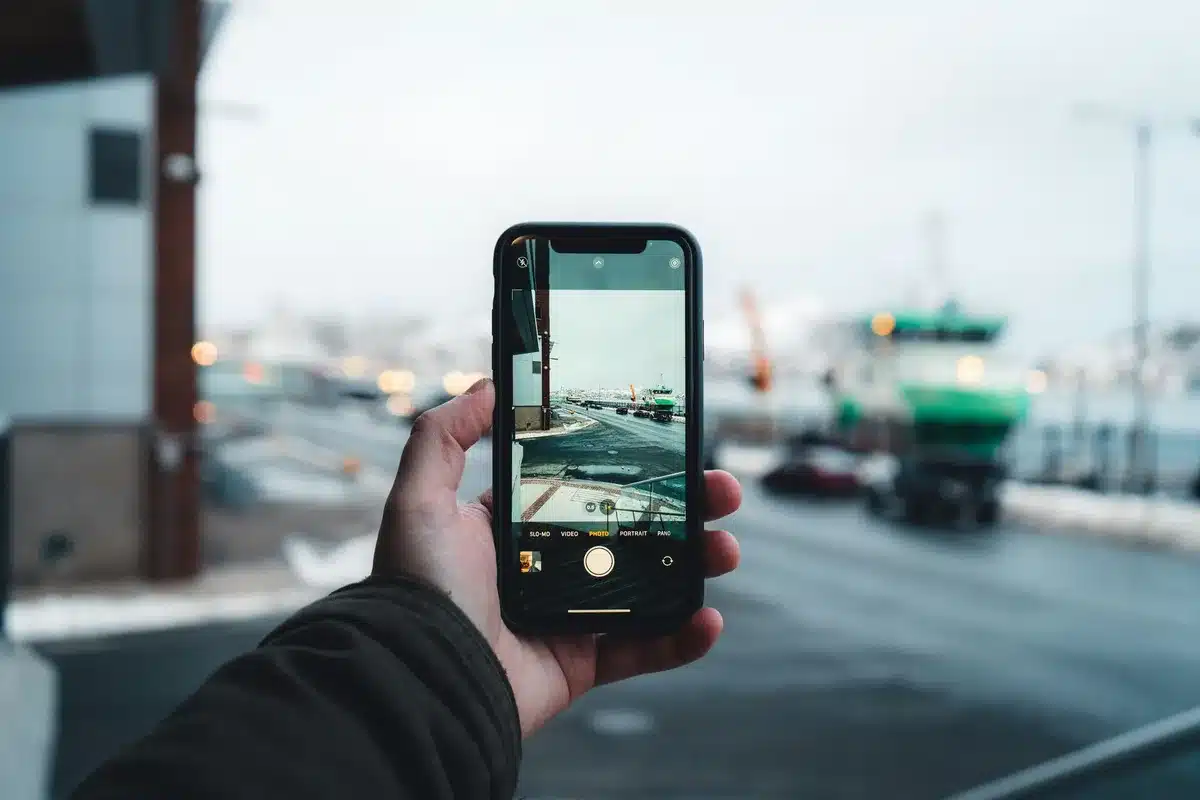 A smartphone screen displaying the camera app's filter creation interface, with a gallery of photos visible and color palette options highlighted in warm, golden tones.