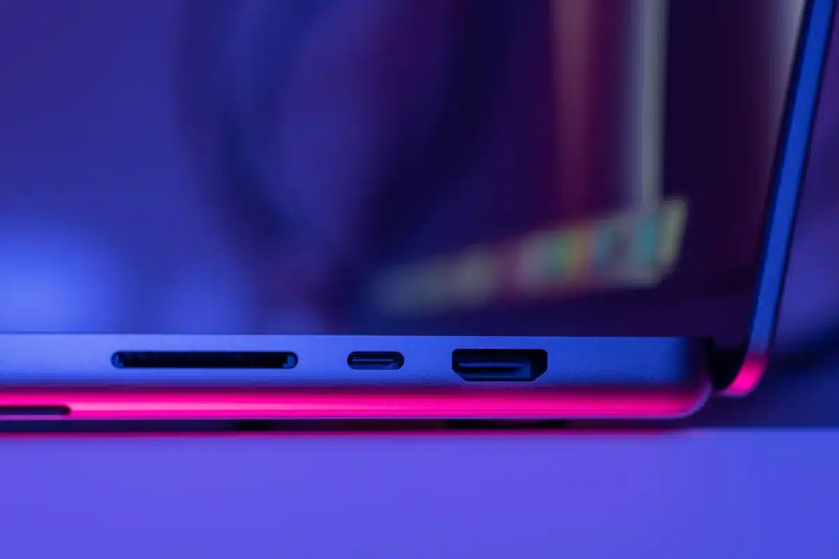 Close-up view of USB-C connector and magnetic attachment point on the back of a portable SSD, showing the technical connection details and metallic finish