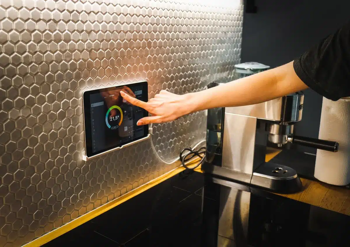 Aluminum tablet body showing side profile with speaker grilles, thin bezel design, matte finish surface catching studio light