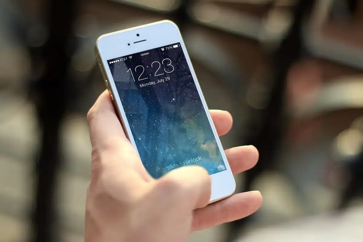 Close-up of anonymous hands holding a smartphone showing a generic payment confirmation screen, no brand, blurred background