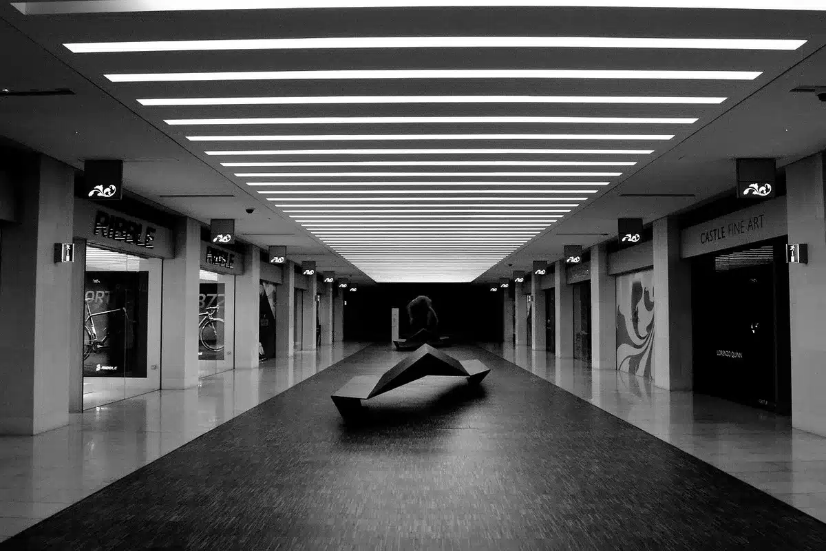 Empty clinic corridor with an unbranded poster about women's health on the wall, no people, fluorescent lights