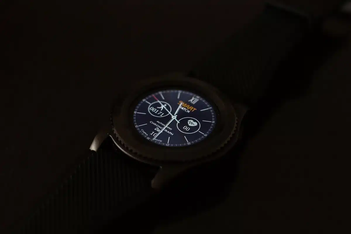 A close-up of an unbranded sport smartwatch face showing workout metrics on-screen, placed on a textured gym bench