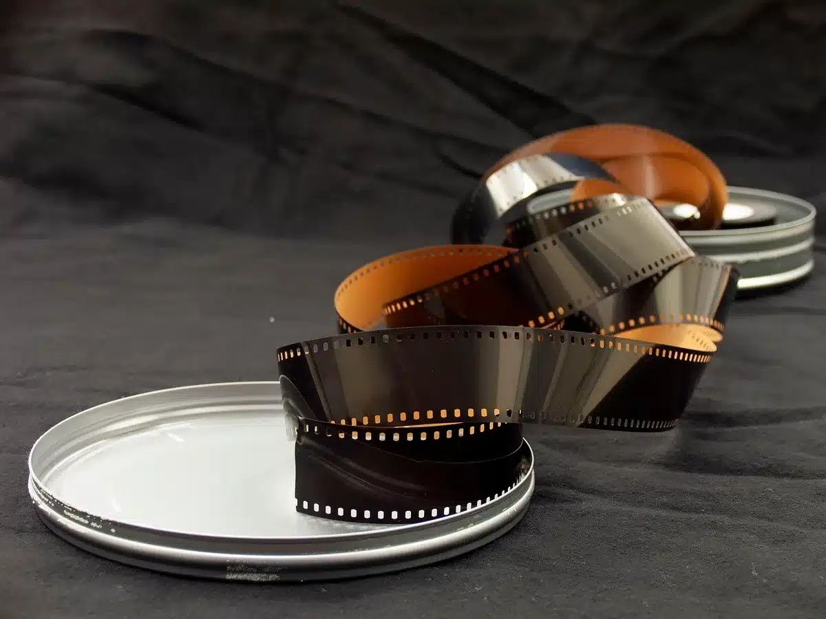 close-up of a vintage film clapper beside an unbranded VHS tape