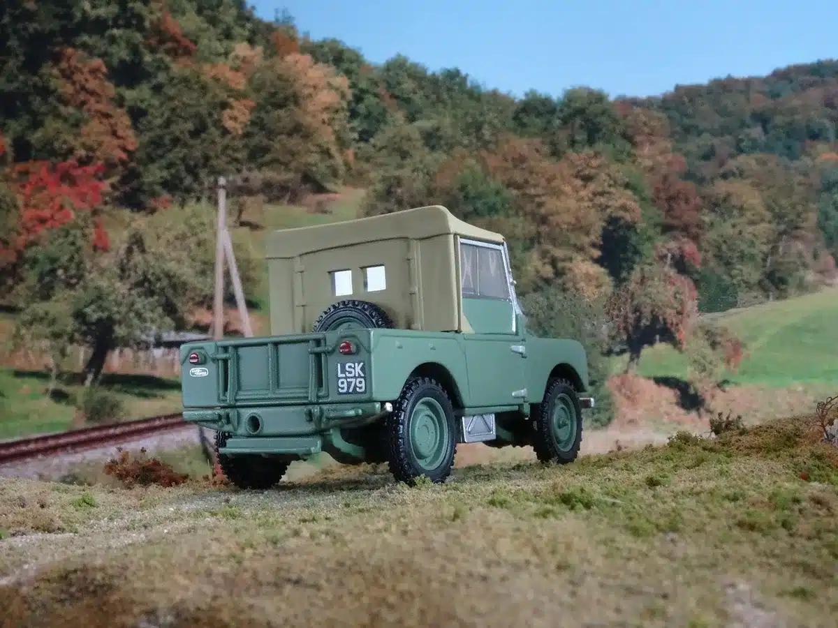 Close-up of four unbranded all-terrain vehicles lined up on gravel, equipment cases nearby, empty scene