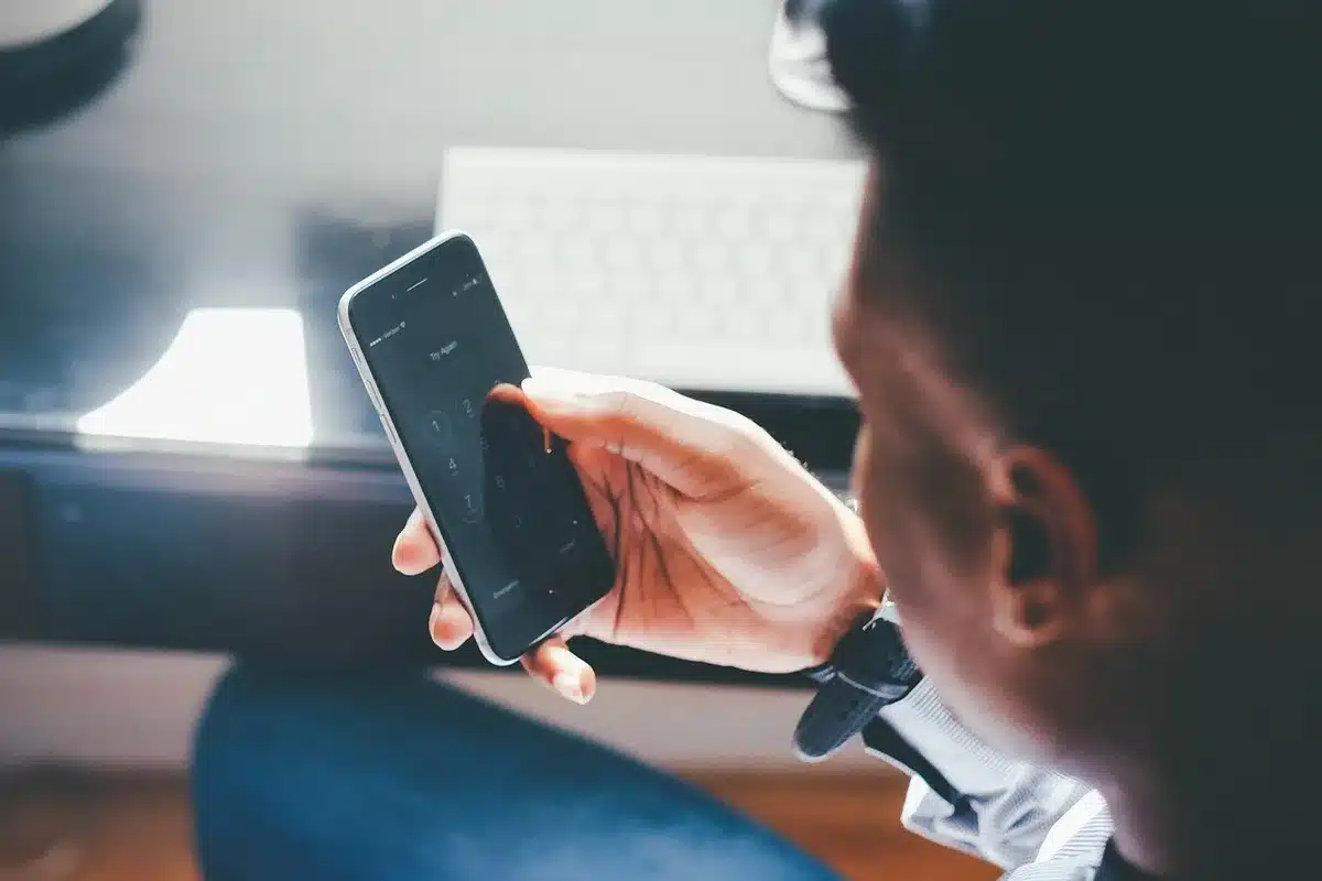 empty smartphone on a table with a notification bubble that reads 'Possible scam' blurred