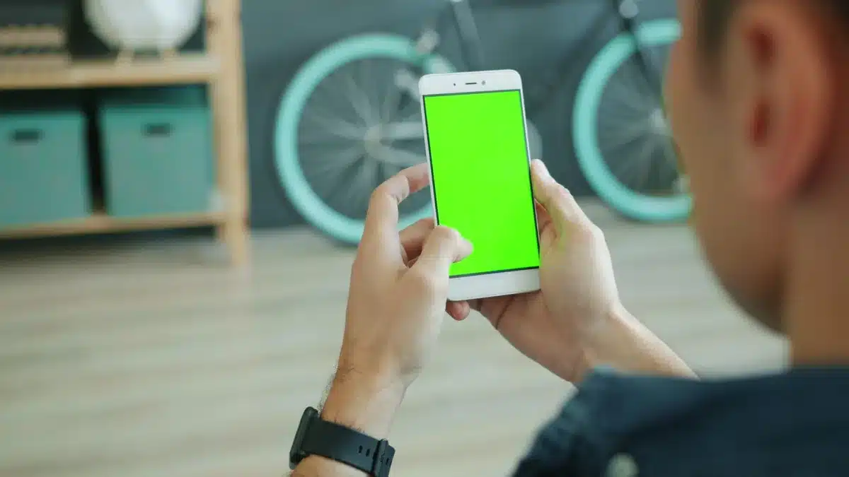 Empty store shelf with boxed, unbranded smartphones lined up, a lone price tag placeholder visible, soft overhead lighting