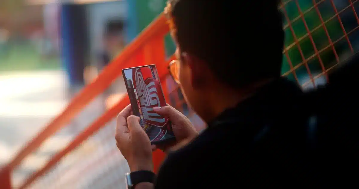 A wide empty display lit from above on a simple table suggesting a larger foldable phone, no logos, no people