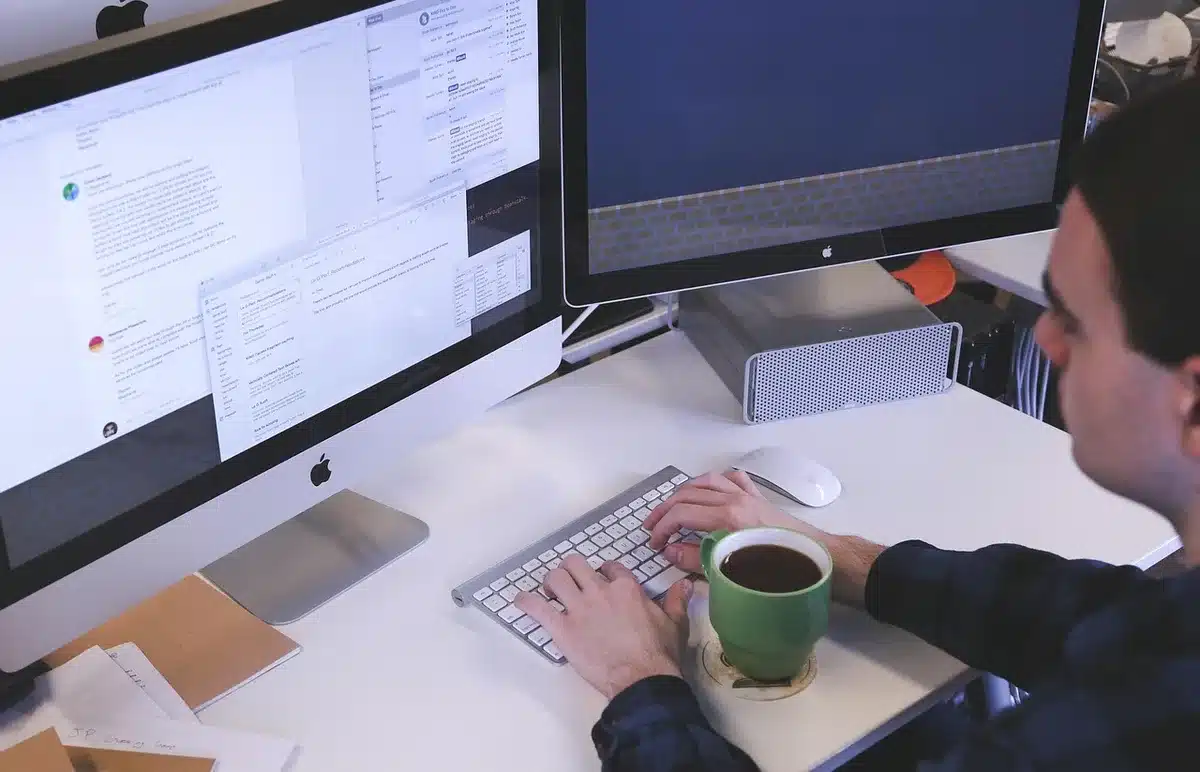 A sleek, anonymous gaming monitor on a minimalist desk showing a crisp bright game scene, no logos, soft backlight