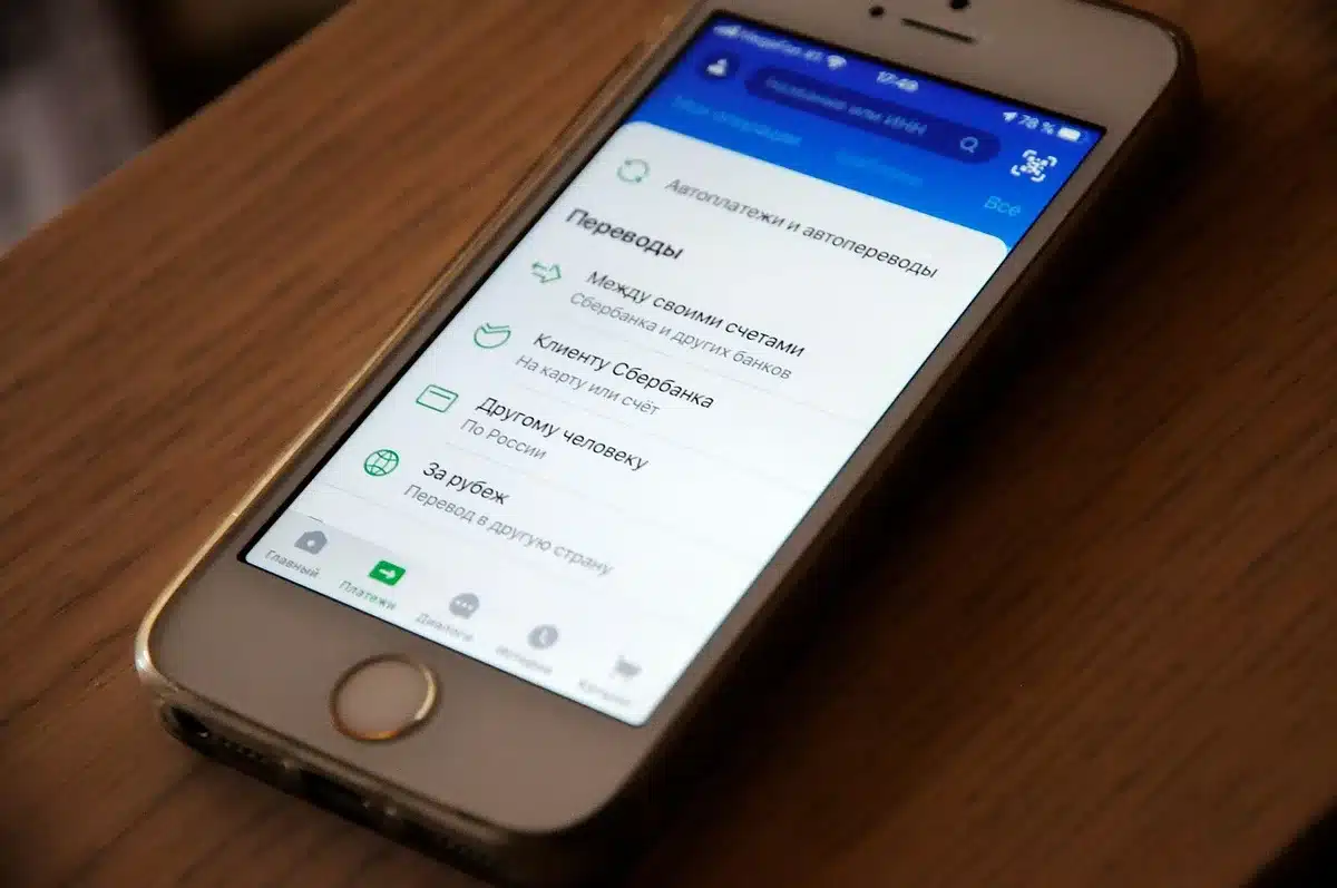 A smartphone screen showing an alternative app store interface with colorful app icons, emphasizing the absence of familiar Google branding, displayed in warm indoor lighting