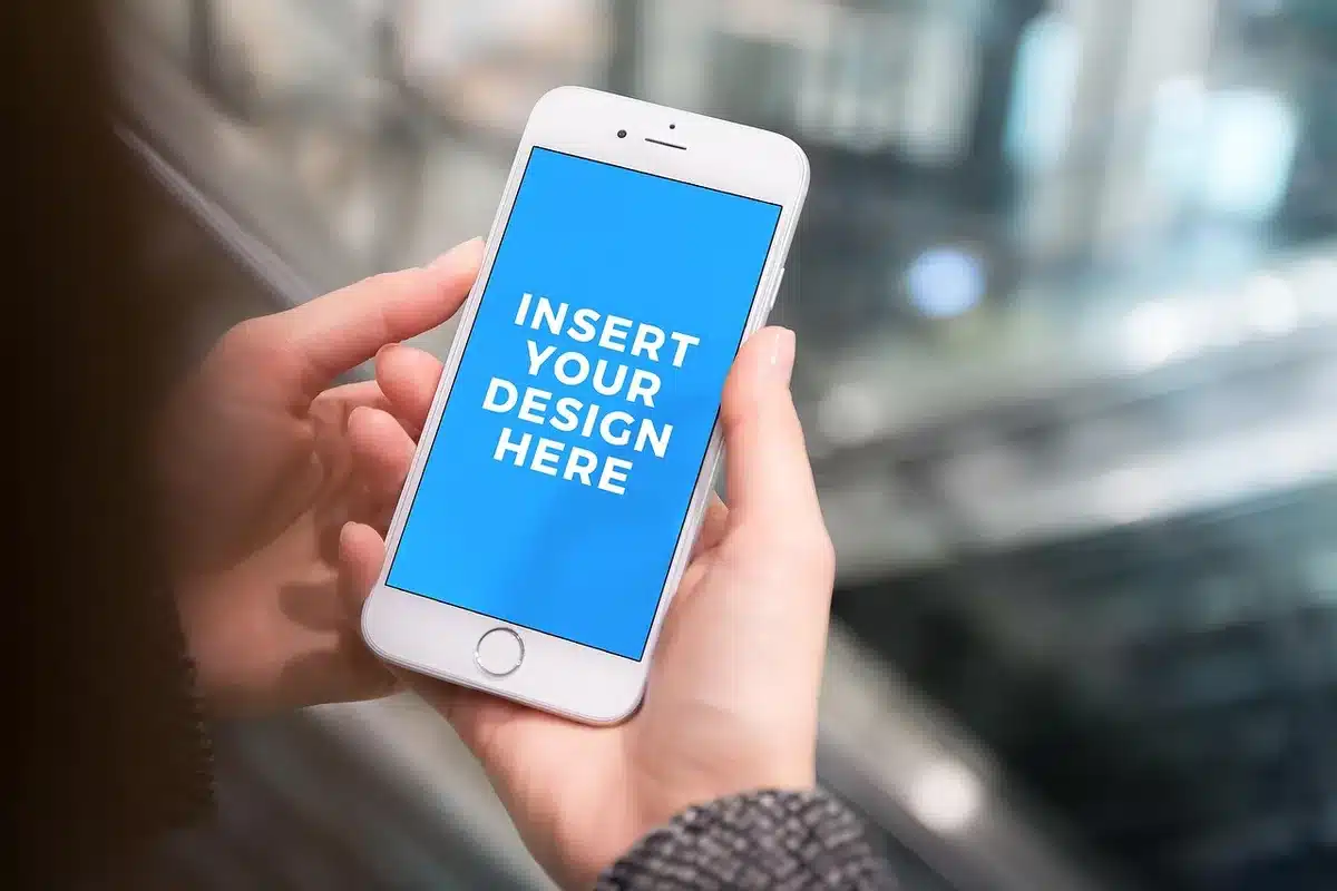 Smartphone display showing vibrant AMOLED screen with high refresh rate graphics, hands holding device at an angle, modern tech environment