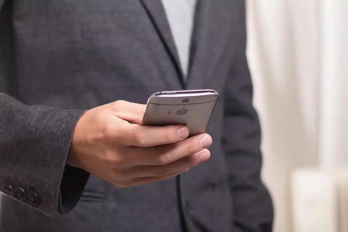 close-up of an anonymous smartphone screen showing a blue messaging icon next to a chat thread, no logos or visible faces