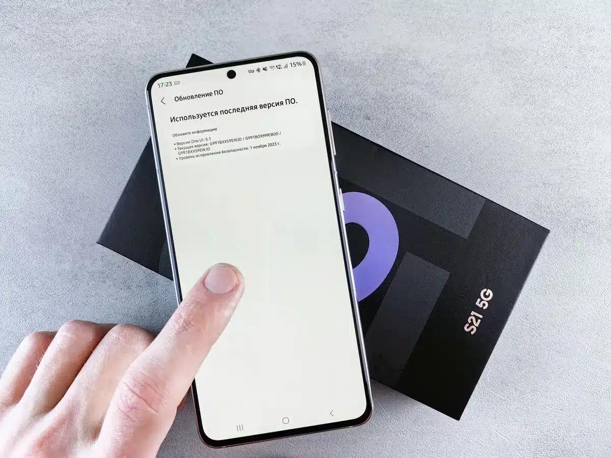 A close-up scene of an unbranded smartphone box with a decorative, magical-themed sleeve and a small collector's card beside it