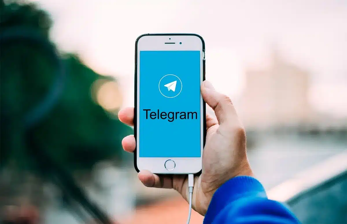 A close-up of a smartphone screen showing a chat conversation with an AI assistant, with a subtle speaker silhouette in the background, minimalist design with soft lighting, no readable text or brand names visible