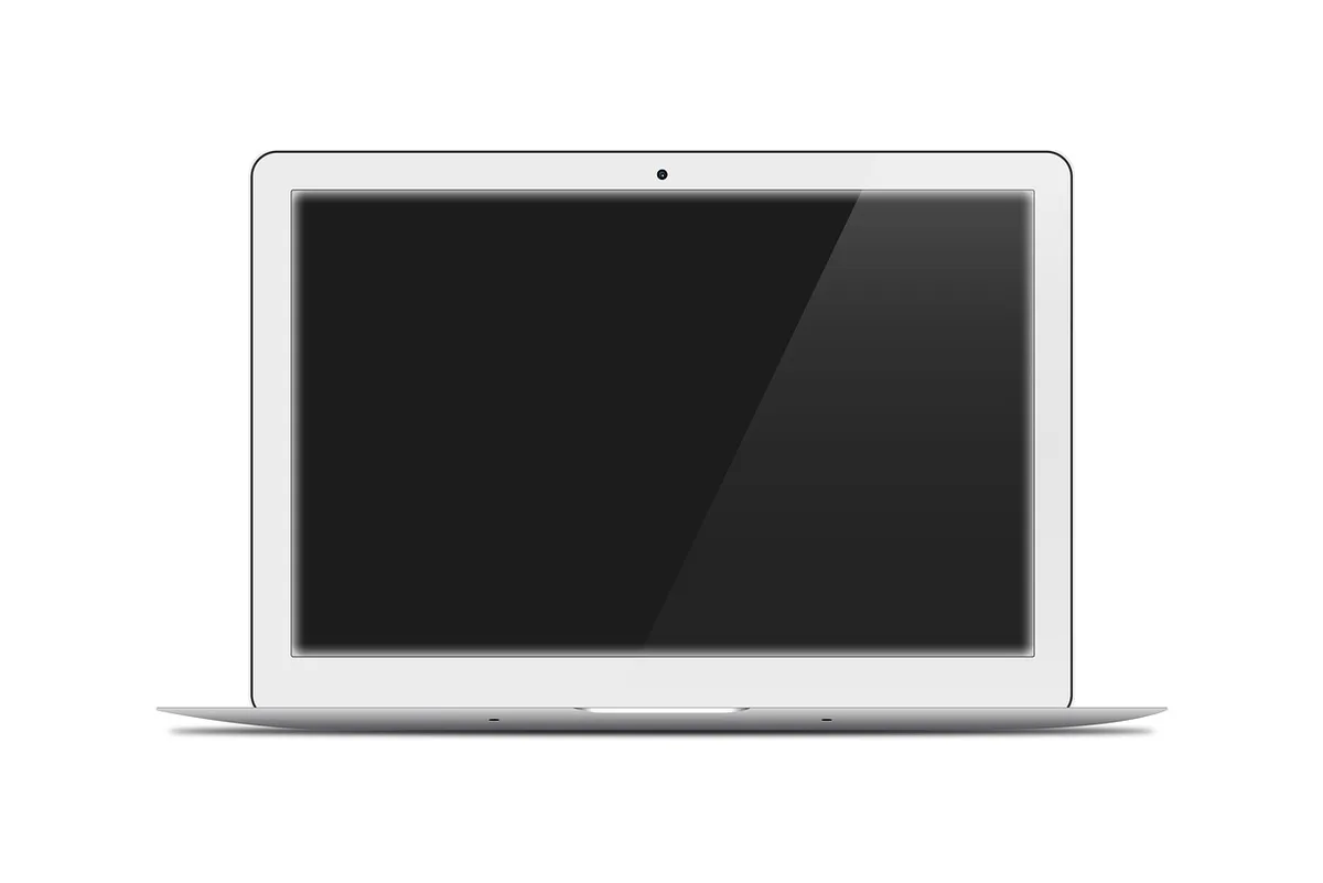anonymous hands using a portable monitor next to a closed laptop, screen showing neutral desktop, no logos