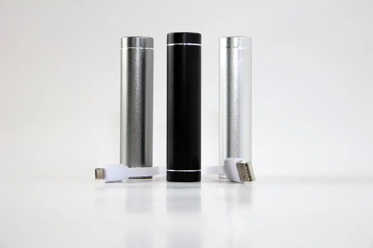 A sleek smartphone with a massive battery indicator glowing inside, displayed on a minimalist dark surface, highlighting the 10000 mAh capacity and slim profile despite the large power cell.