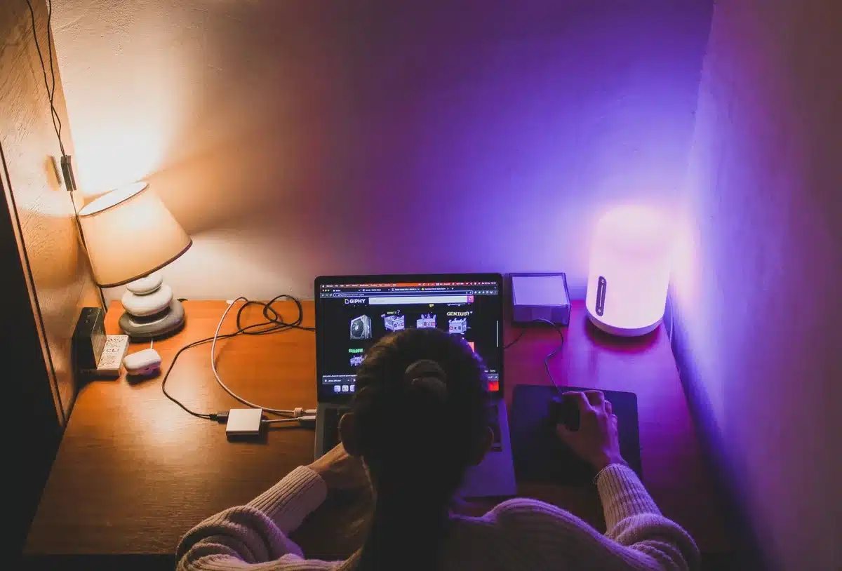 empty living room with a generic modern Wi-Fi router on a shelf, soft evening light, devices like a laptop and smart speaker blurred in background