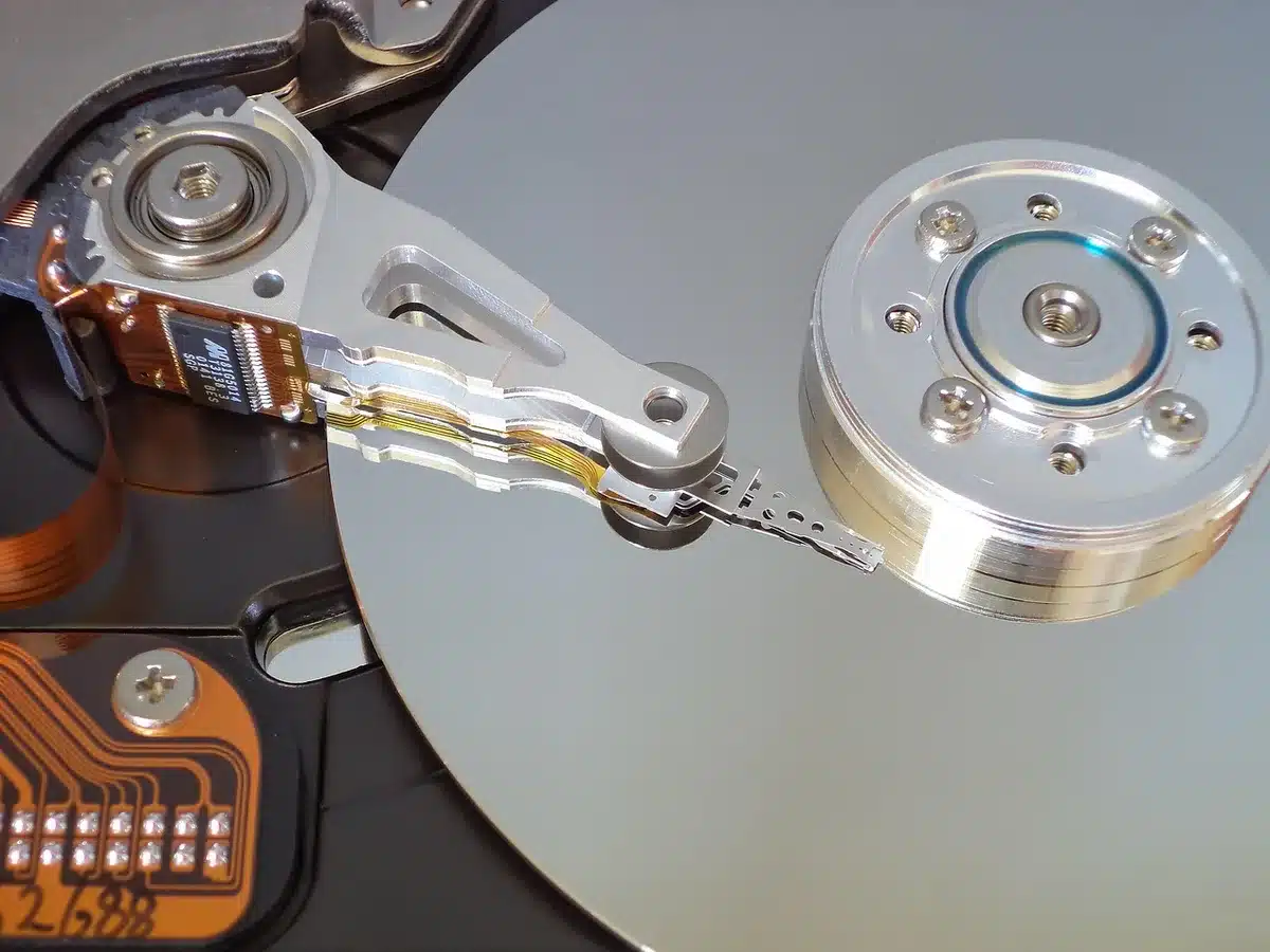 An external USB drive plugged into a laptop next to a stopped backup progress screen, no visible brands or logos