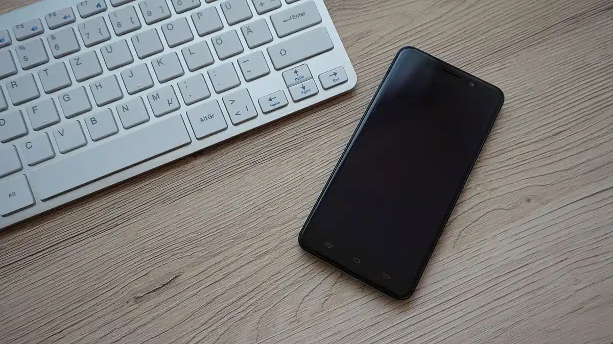 Empty smartphone on a table with app icons blurred on the screen, anonymous and unbranded