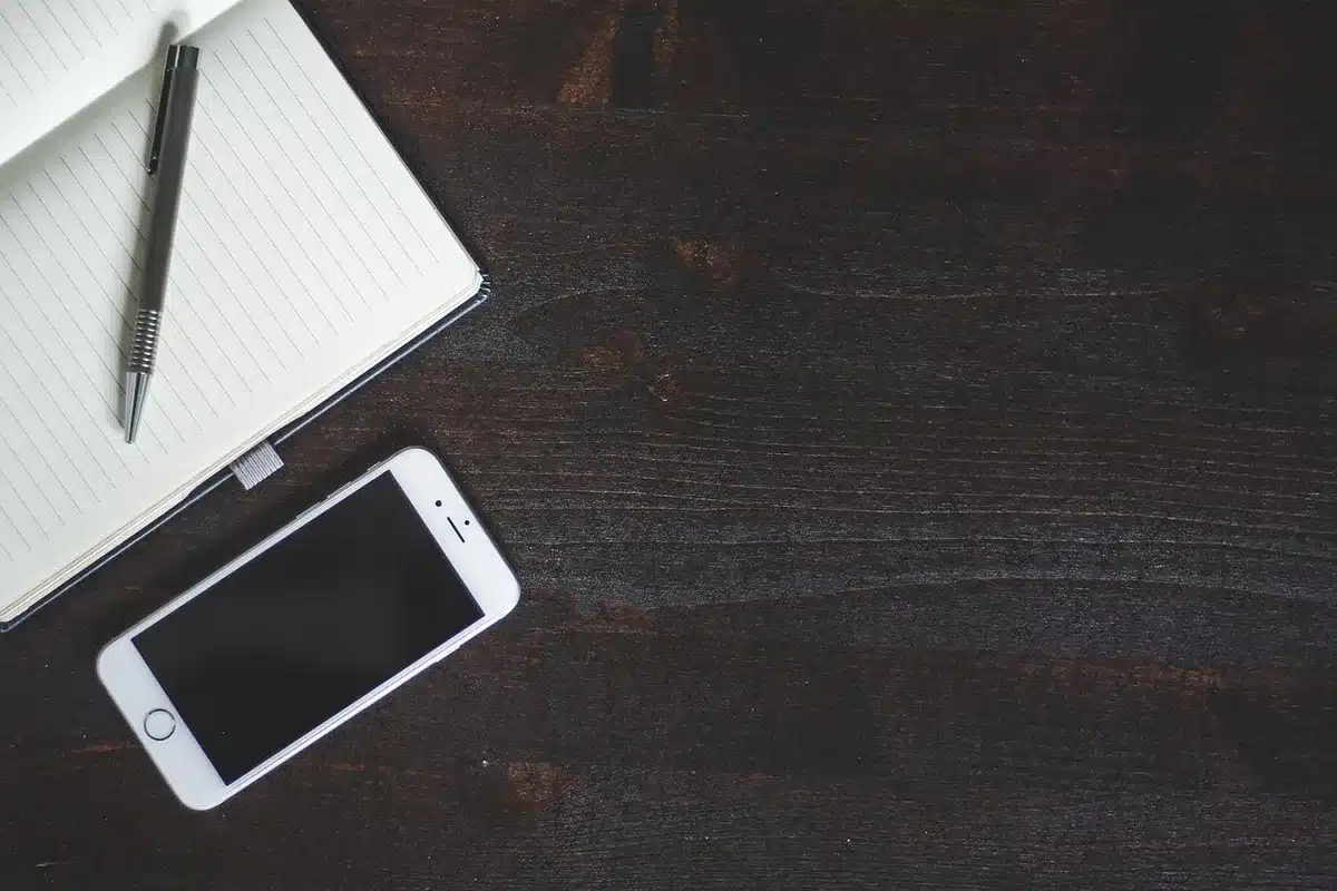 anonymous close-up of a folded unbranded smartphone showing external screen and hinge detail on a neutral table