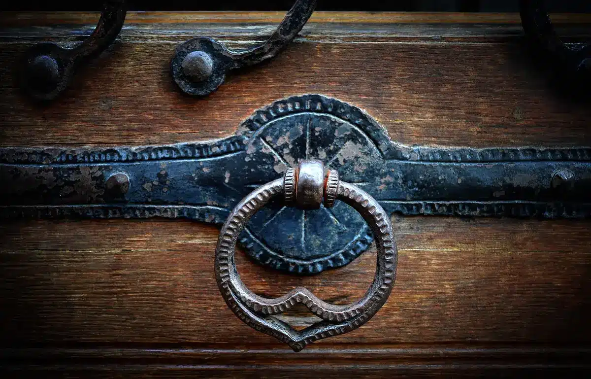 Close-up of textured resin panels and a generic padlock on a storage door, daylight, no branding