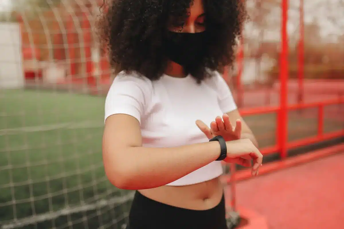 slim fitness tracker on a neutral wrist, no logos, curved AMOLED display visible
