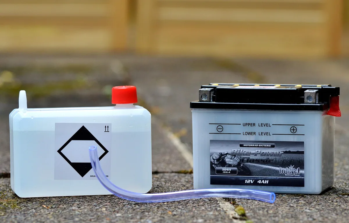 close-up of an unbranded aluminum tracker case and spare battery pack on a table