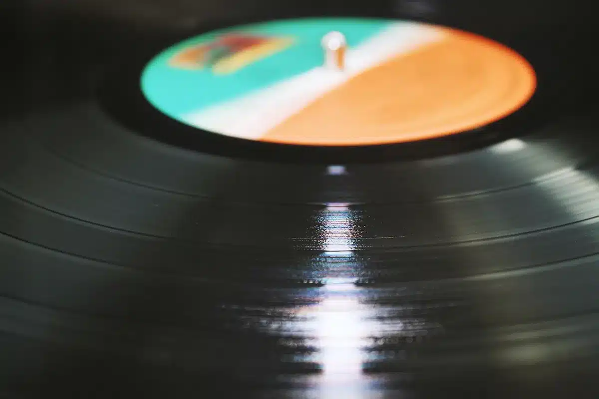 Two limited-edition vinyl records on a plain table, colorful marbling visible, sleeve art leaning behind them