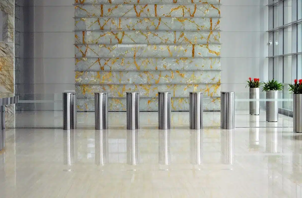 Empty hotel lobby with distant anonymous figures, deserted check-in desk and scattered brochures