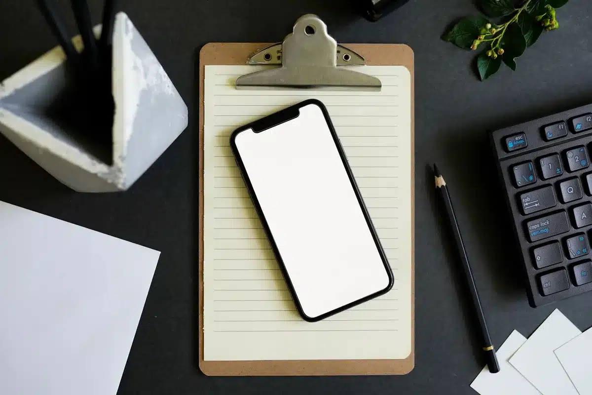 Empty stage with a single smartphone mock-up under a spotlight; no brand or text