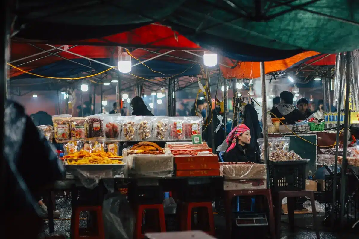 Anonymous silhouette of a marketplace stall with stacked unbranded fruit boxes and an empty weighing scale