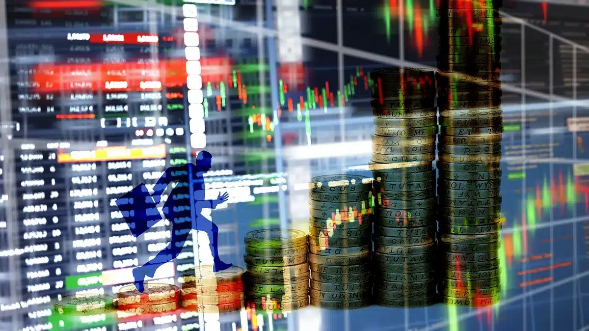 Anonymous silhouettes at a trading desk looking at multiple screens showing financial charts, blurred faces, no logos