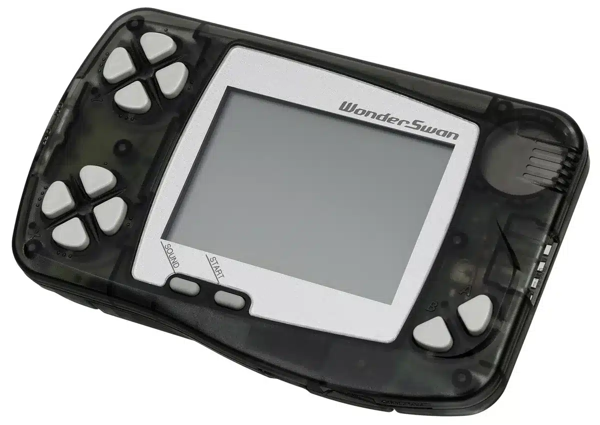 A translucent black handheld console on a display pedestal, gold internal accents visible through the shell, no logos or text