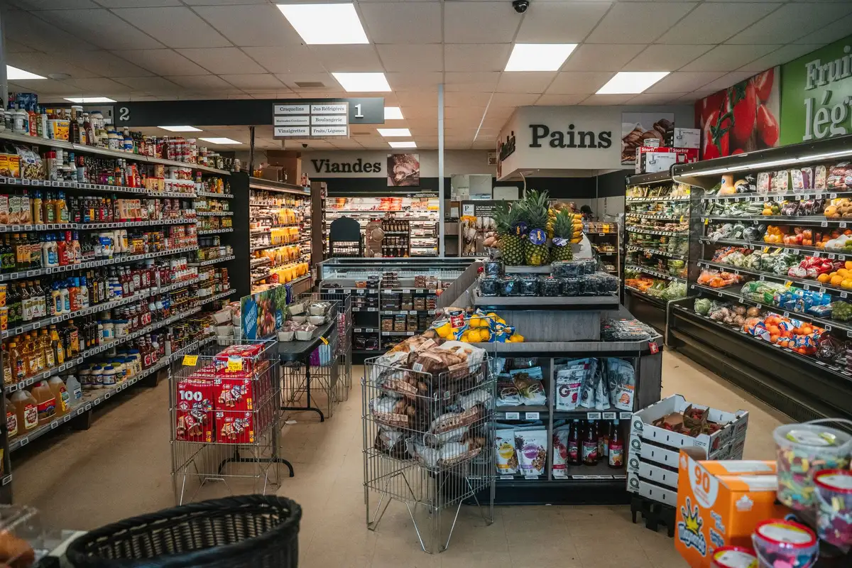 Anonymous supermarket aisle with seasonal displays and price tags visible, no logos or identifiable people