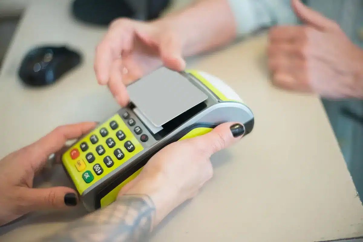 close-up of an anonymous hand entering a coupon code on a generic tablet checkout page, blurred background, no logos